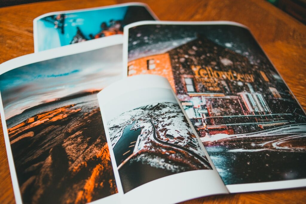 A person holding two art prints side by side, one with a glossy finish and one with a matte surface.