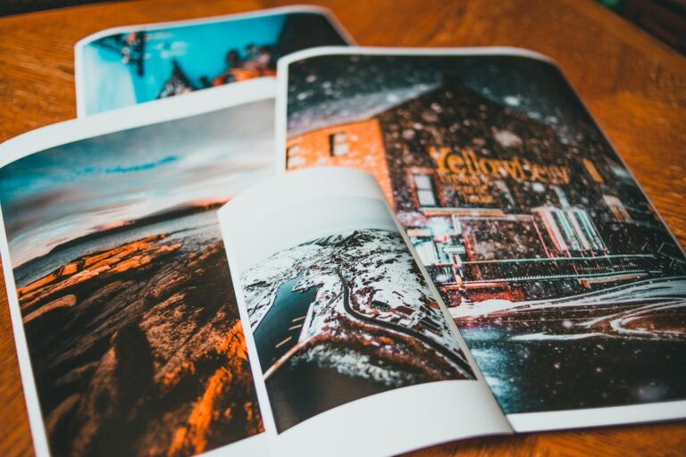 A person holding two art prints side by side, one with a glossy finish and one with a matte surface.
