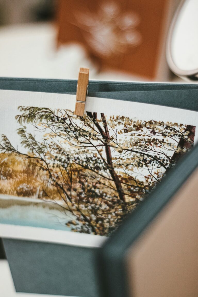 Person inspecting a framed art print for fading or damage in a well-lit home living room.